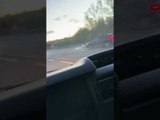 Pickup Truck Driving Dangerously Down the Road Drops Cargo Onto Oncoming Traffic