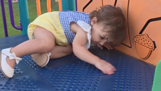 Baby girl's 1st adventure on playground slide turns into a comical catastrophe