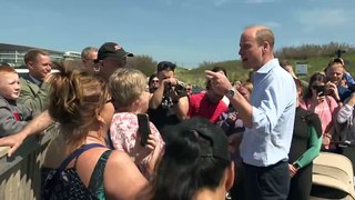 Prince William poses for selfies with public on the beach