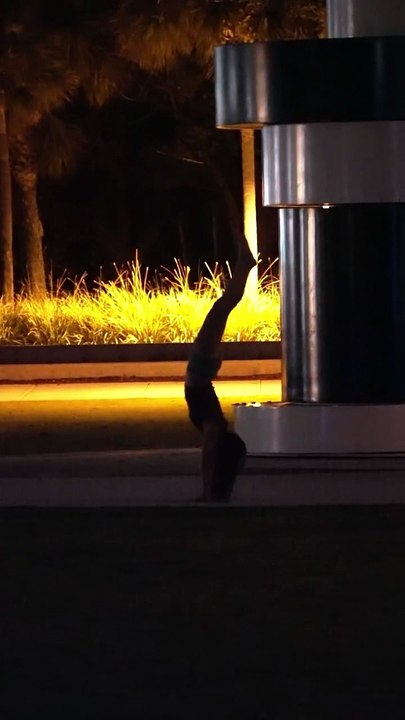 She was trying to walk on her hands at South Pointe Park in Miami Beach, Florida