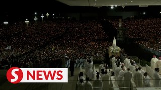Thousands of worshippers descend on Portugal's Fatima to pray for peace