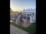 Women Trip and Fall While Attempting to Catch Bouquet Tossed by Bride