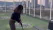 Girl Repeatedly Fails Hitting Golf Ball at Driving Range