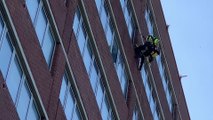 Worker abseiling down the side of Ocean House in St Leonards, East Sussex