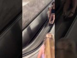 Woman Falls After Sliding Down Escalator