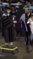 Teachers College graduate brings keffiyeh wrapped baby to graduation