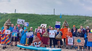 People gathered on Cresswell Beach for a national protest