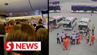 Moments of SIA passengers being carried out of flight after turbulence incident