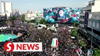 Iranian mourners march through Tehran streets, bid farewell to president