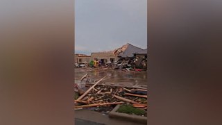 Debris scattered around damaged buildings after tornados rip through Texas city
