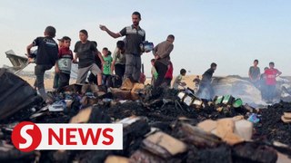 Palestinians look through ashes for belongings after overnight strike on Rafah