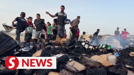 Palestinians look through ashes for belongings after overnight strike on Rafah