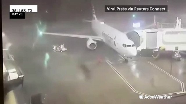 Parked airplane blown away by storm winds at Dallas airport