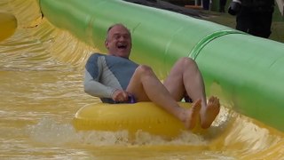Ed Davey rides rubber ring on waterslide as Lib Dems campaign about children’s mental health