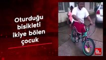 Oturduğu bisikleti ikiye bölen çocuk