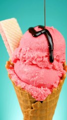 mixkit-strawberry-ice-cream-cone-with-chocolate-syrup-on-a-blue-10378-hd-ready