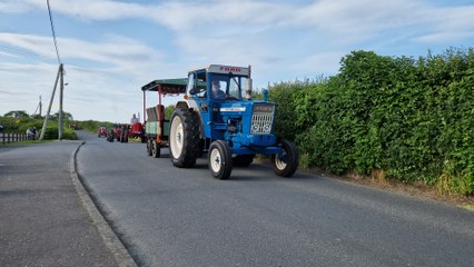 Tractors make their way by St Patrick's Church during the St Columba's College tractor run at Portaferry, Co Down