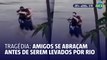 Amigos se abraçam antes de serem levados por rio na Itália