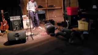 Man Trips and Falls While Playing Guitar
