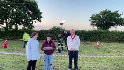 Lighting of beacon while Bella Gurney reads tribute (Will Goddard, Crediton Courier)