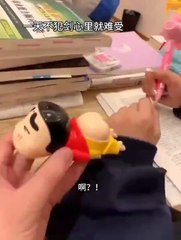 What is this boy doing with a plastic toy?