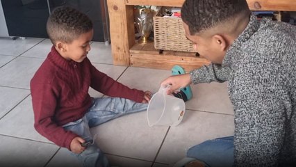 Creative cleaning: Dad's quick thinking makes a water spill disappear