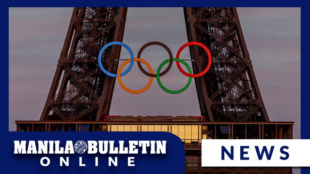 The Olympic rings are mounted on the Eiffel Tower to mark 50 days until the Paris Games