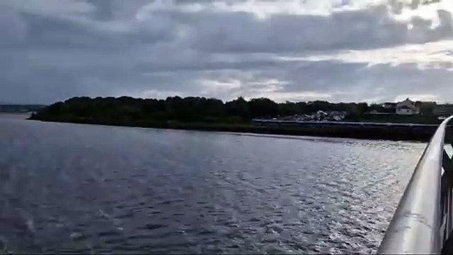 Translink train going under the Peace Bridge in Derry