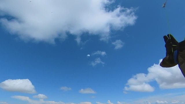 Person Paraglides in Paragliding Competition