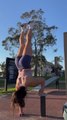 Woman Performs Single Arm Hand Stand