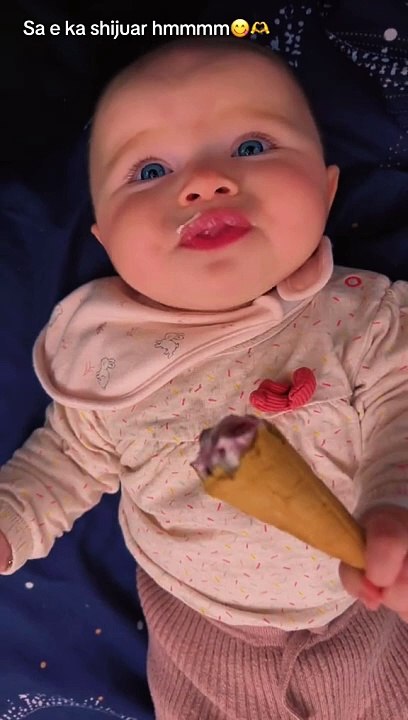Cute baby eating cone