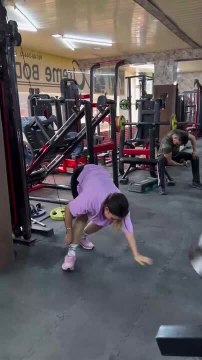 Woman Fails to Lift Heavy Weight and Hangs on Cable