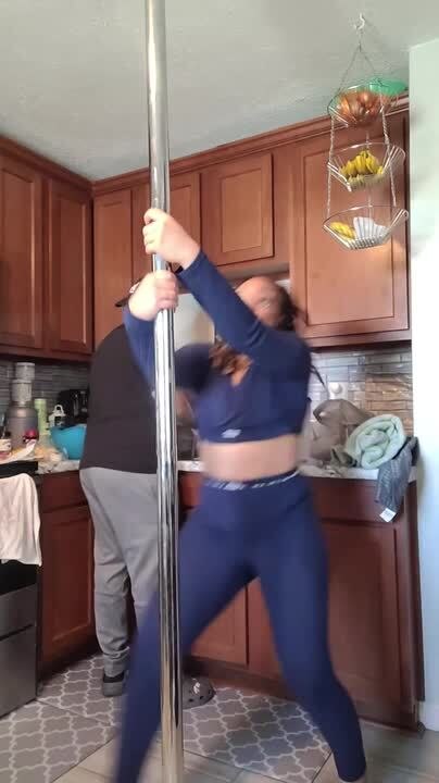 Woman Falls Hard While Pole Dancing in Kitchen