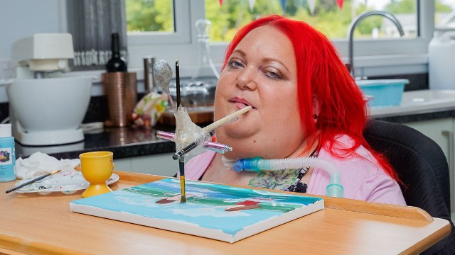 Woman paralysed when she fell learning to walk as baby paints art with mouth