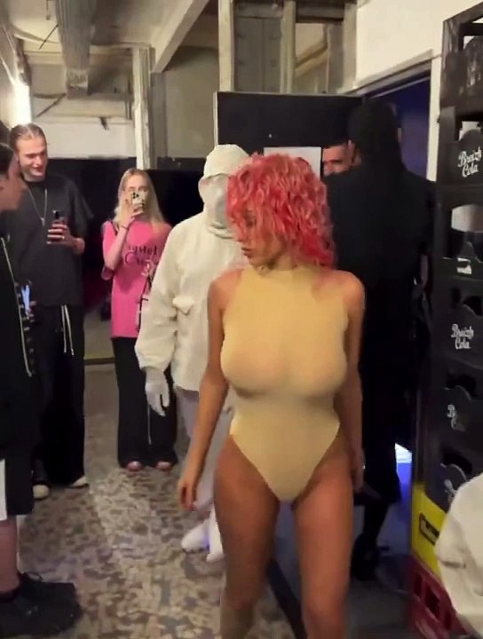 Kanye West sparks controversy for his Paris Fashion Week outfit, which includes a white hood