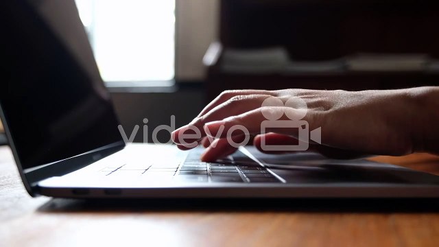 Closeup hands working and typing on laptop keyboard