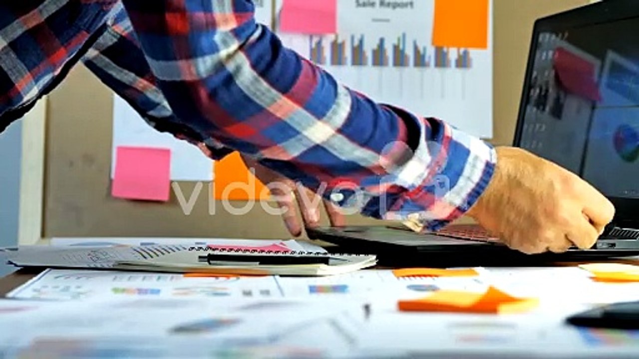 Hand of businessmen using laptop examine account calculated financial reporting, with charts, graphs