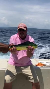 Guy on Boat Catches Fish and It Bites His T-shirt