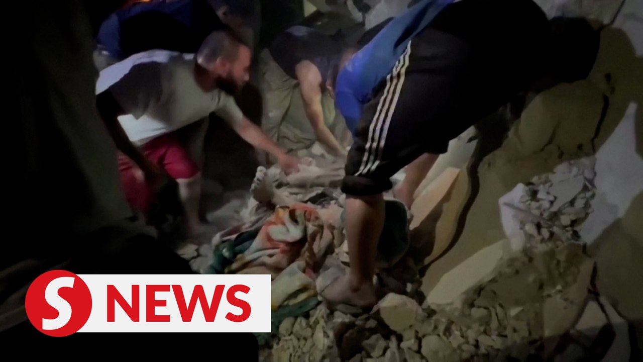Gazans pull children casualties from under the...