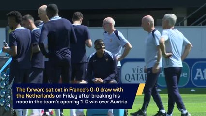 Masked Mbappe trains with France