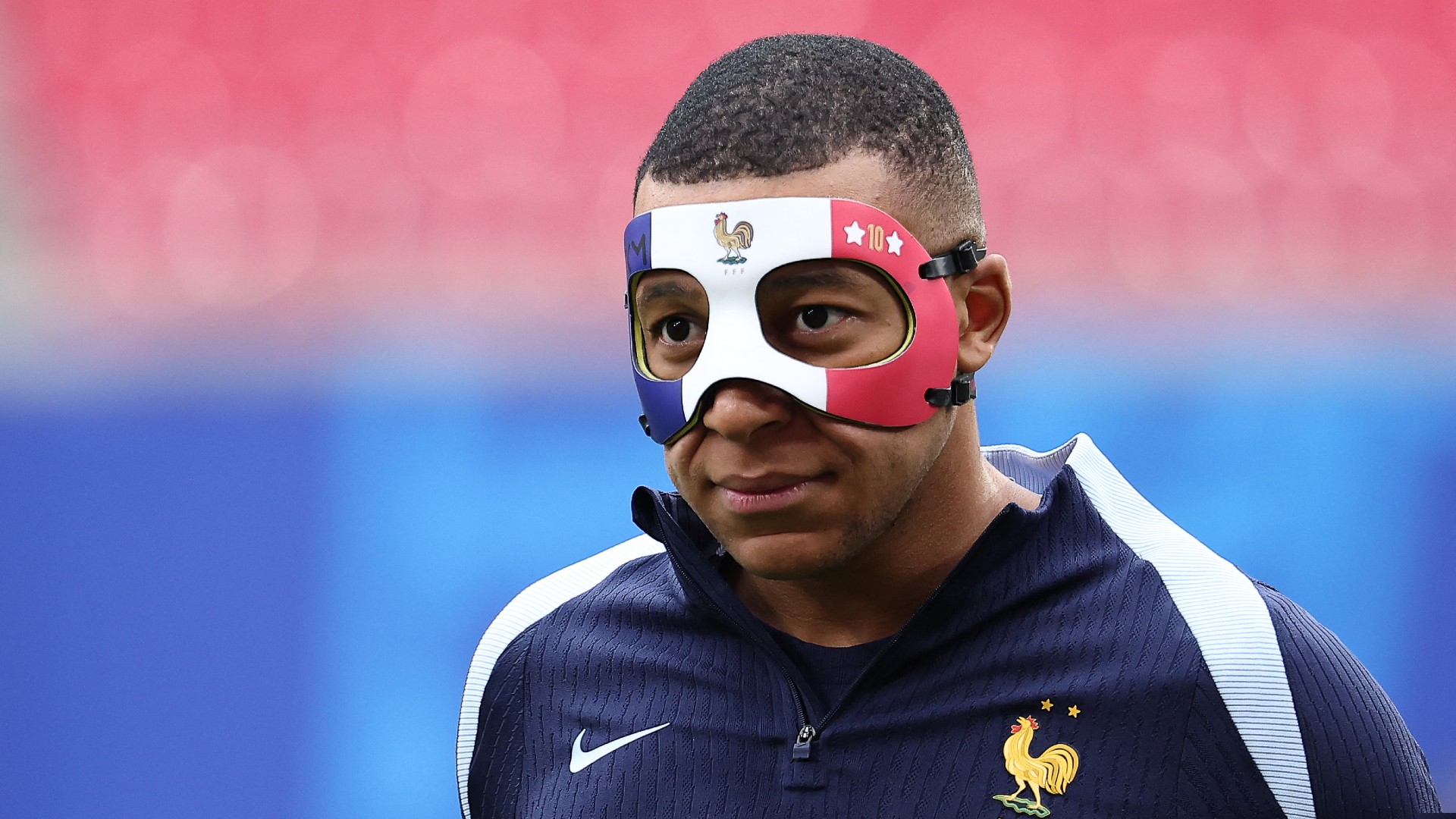 Masked Mbappe trains with France