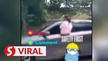 Video of girl seated on window sill of moving car goes viral, mum arrested