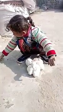 Cute baby playing with baby rabbits