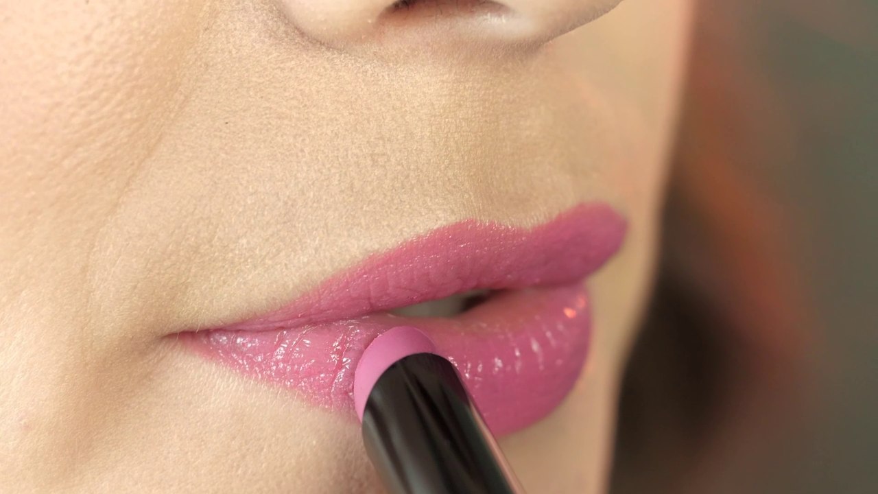 woman-applying-pink-lipstick-371-full-hd