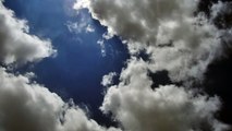 Blue sky background as the clouds travel blown by the wind