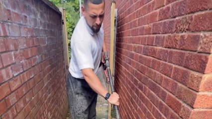 Pressure washing transforms a neglected alleyway into a clean space