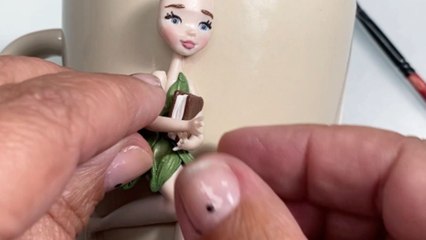 Artist's enchanting polymer clay 'Tinkerbell' decoration transforms plain mug into unique masterpiece