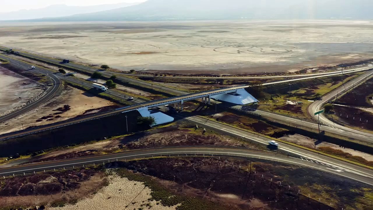 Highway overpass a dry lake and mountain in the distance