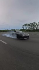 Black Sports Car Loses Control on Wet Highway and Taps Bumper of Other Vehicle