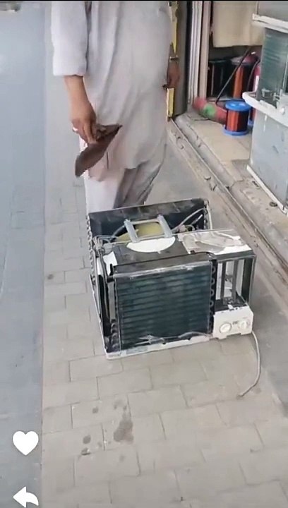 A man from  Pakistan effortlessly lifts the AC unit as if it's a piece of cake. A word for Pakistanis?